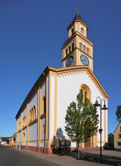 Neo-romanesque church with high bell tower in the village of Lingenfeld in Germany