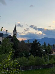 Fototapeta premium Charming village church and serene landscape at sunset in Austria