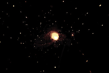 A bright flash of light and a sheaf of sparks in a cloud of smoke. Miniature Universe. Design...
