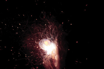 A bright flash of light and a sheaf of sparks in a cloud of smoke. Miniature Universe. Design...