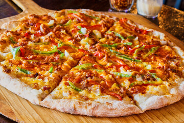 three meat and veggie loaded pizza