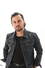 Obraz premium Handsome young man wearing denim jacket and looking at the camera. 