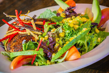 southwest grilled chicken salad with avocado and tortilla strips