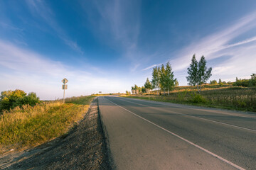 Fototapeta premium A road with a sign on the side of it