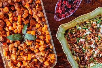 Holiday side dishes consisting of sweet potato stuffing, cranberry sauce and green bean casserole