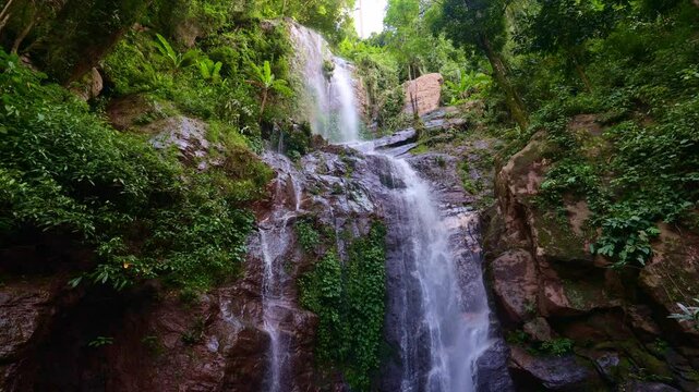 The Huai Tueng Thao waterfall flowing down a high rocky cliff, Mae Rim, Thailand