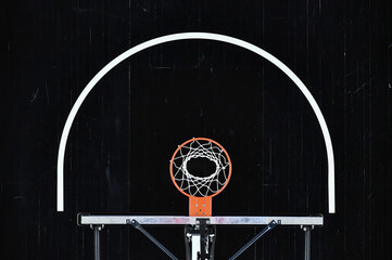 Basketball Hoop Top Down View Against a Black Wood Floor © Myk Crawford