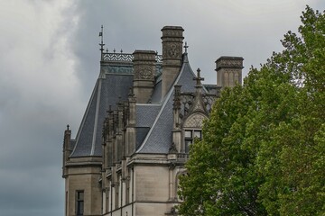Gilded age building against a cloudy sky