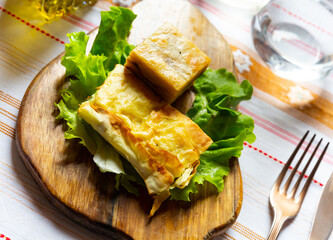 Flija - baked puff pastry with cream or cheese. Served on a lettuce leaf. Albanian or Kosovo cuisine