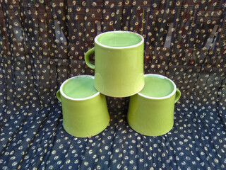 Stacked green colors cups on black background