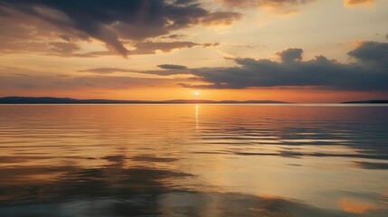 Fototapeta premium Tranquil Sunset Over Calm Water Surface