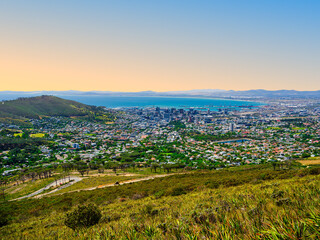 Fototapeta premium Cape Town city view from Table Mountain, featuring Atlantic Ocean and clear blue sky, South Africa