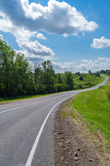 Rural highway road that curves to the right on summer day