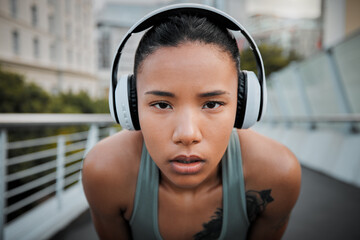 Woman, portrait and headphones outdoor for fitness, exercise and music with determination and...