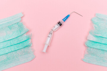 Anti Vaccine Movement and Anti Mask Concept - Broken Medical Syringe and Green Torn Medical Face...