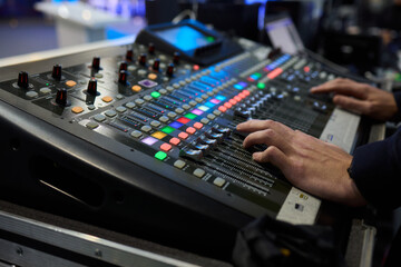 This is a professional audio mixing console that features colorful faders for enhanced usability