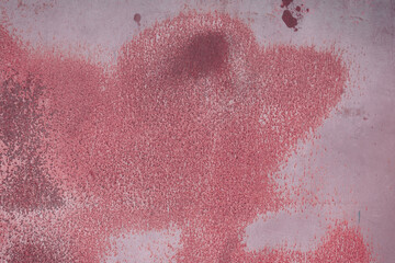 Fragment of a rusty grunge surface. Dark red background color. Scuffs and peeling of old paint....
