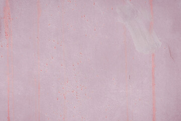 Fragment of a rusty grunge surface. Dark red background color. Scuffs and peeling of old paint....