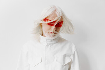 Abstract portrait of an elderly man with flowing white hair, wearing red blindfold glasses against a minimalist white background, conveying a sense of mystery and contemplation