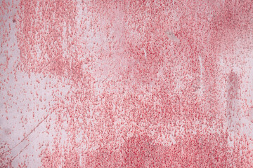 Fragment of a rusty grunge surface. Dark red background color. Scuffs and peeling of old paint....