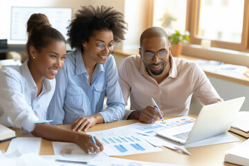 A diverse team of professionals meeting reviewing data and discussing growth strategies in a collaborative office environment, showcasing teamwork, analytical thinking and shared goals in a workspace
