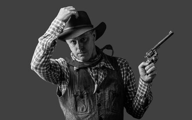Fototapeta premium Western man with hat. Man wearing cowboy hat, gun. West, guns. Portrait of a cowboy. Black and white