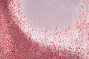 Fragment of a rusty grunge surface. Dark red background color. Scuffs and peeling of old paint....