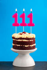 Red velvet birthday cake with number 111 candle