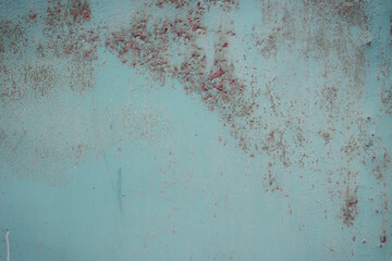 Fragment of a rusty grunge surface. Green-brown background color. Scuffs and peeling of old paint....