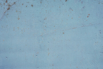 Fragment of a rusty grunge surface. Blue-brown background color. Scuffs and peeling of old paint....