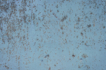 Fragment of a rusty grunge surface. Blue-brown background color. Scuffs and peeling of old paint....