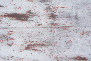 Fragment of a rusty grunge surface. White-brown background color. Scuffs and peeling of old paint. Scratches and traces of a welding seam.