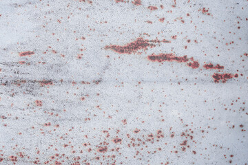 Fragment of a rusty grunge surface. White-brown background color. Scuffs and peeling of old paint....