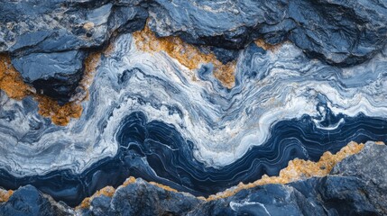 Fototapeta premium Abstract Blue and White Swirling Pattern on Black Rock