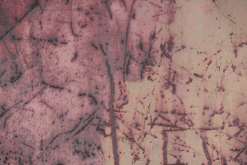Fototapeta premium Fragment of a rusty grunge surface. Orange-green background color. Scuffs and peeling of old paint. Scratches and traces of a welding seam.