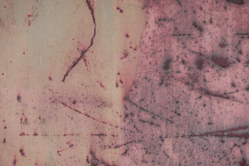 Fragment of a rusty grunge surface. Orange-green background color. Scuffs and peeling of old paint....