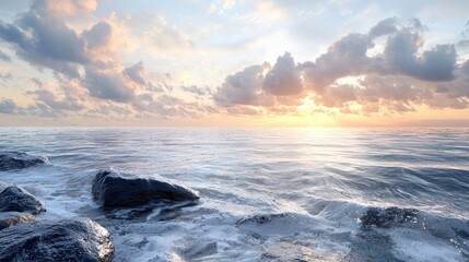 Obraz premium Sunset Over the Ocean with Rocks in the Foreground