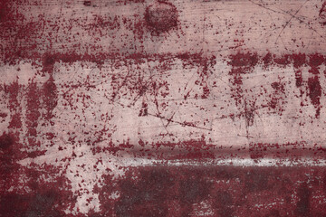 Fragment of a rusty grunge surface. Orange-brown background color. Scuffs and peeling of old paint....