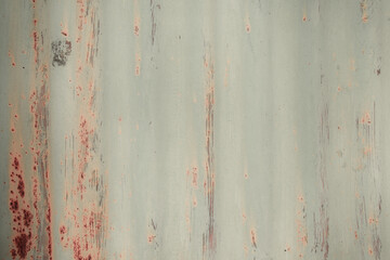 Fragment of a rusty grunge surface. Orange-brown background color. Scuffs and peeling of old paint....
