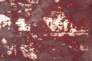 Fragment of a rusty grunge surface. Orange-brown background color. Scuffs and peeling of old paint....