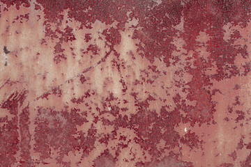 Fragment of a rusty grunge surface. Orange-brown background color. Scuffs and peeling of old paint....