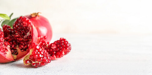 Fresh ripe pomegranates on light background