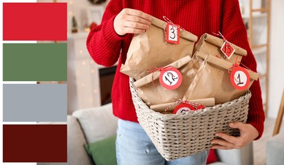 Woman holding basket with Christmas Advent calendar at home, closeup. Different color patterns