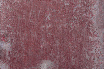Fragment of a rusty grunge surface. Orange-brown background color. Scuffs and peeling of old paint....