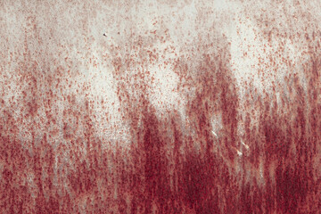 Fragment of a rusty grunge surface. Orange-brown background color. Scuffs and peeling of old paint. Scratches and traces of a welding seam.