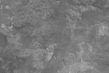 Monochrome texture of a concrete wall with natural relief and damage in the form of chips and...