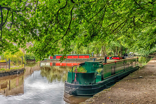 Canal boats moored in Uppermill canal basin on the HUddersfield Narrow Canal, Oldham, England, UK