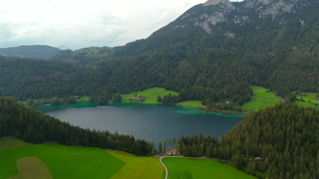 Hintersteiner See mountain lake in Austria near town of Kufstein, aerial view in summer at sunset in cloudy weather. Hintersteiner See in Oesterreich in der Nahe der Stadt Kufstein Luftaufnahme. 
