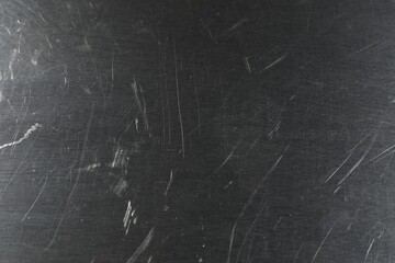 Old metal surface with scratches as background, closeup