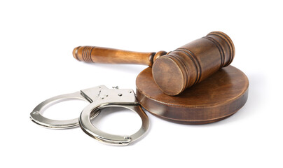 Handcuffs and judge's gavel isolated on white